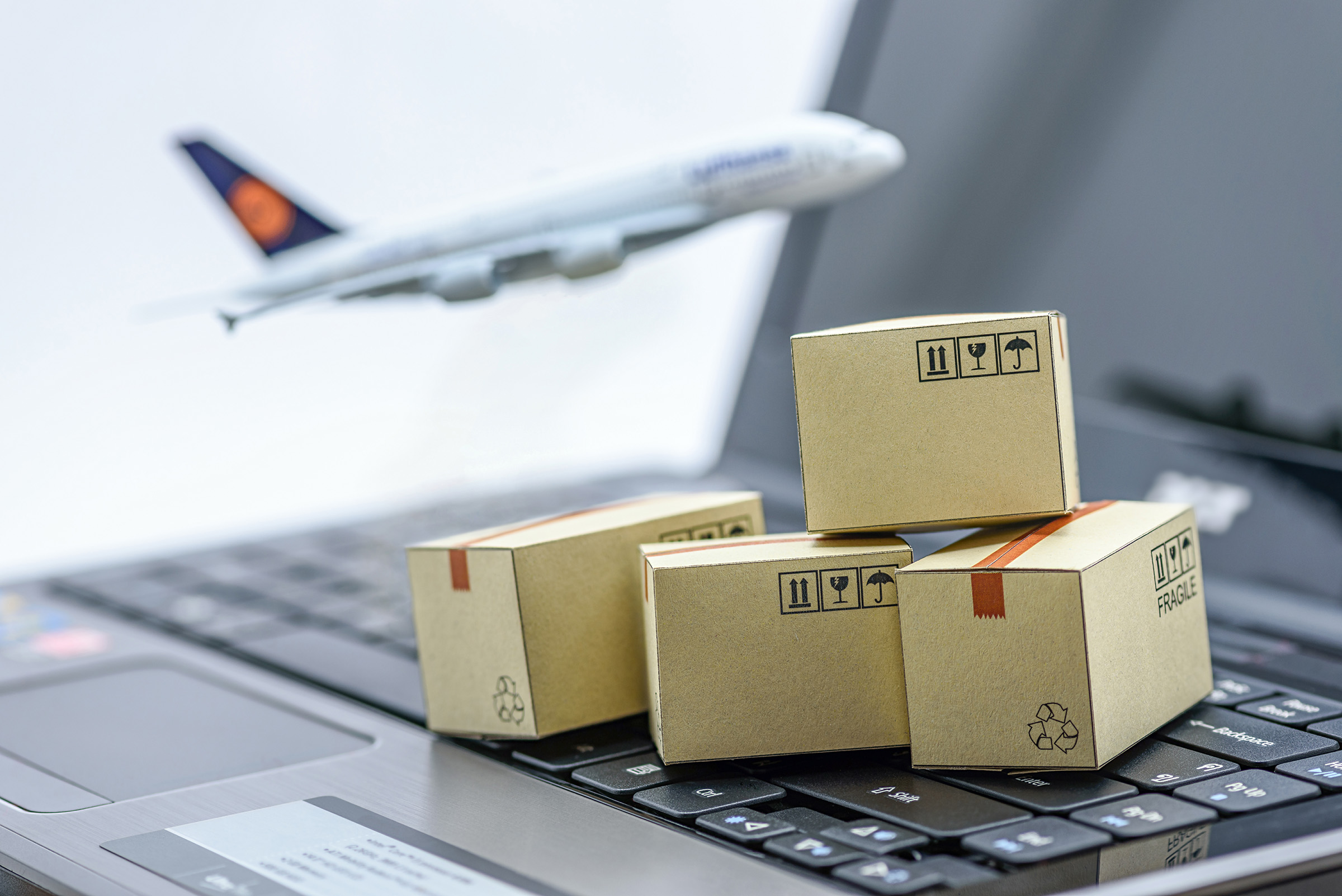 Small decorative cargo boxes put on the laptop keyboard